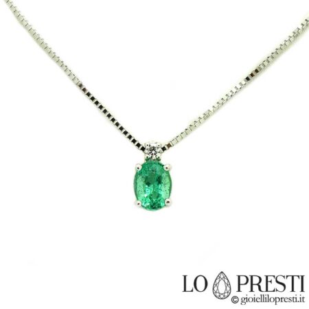 Refined women's light point pendant necklace with oval cut emerald and brilliant cut diamond in 18kt white gold. Lifetime warranty certificate