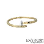 Nail bracelet in 18kt gold and zircons